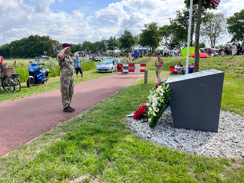 Photo showing a member of the RAF Akrotiri team saluting the memorial to the crew of Lancaster SR-J
